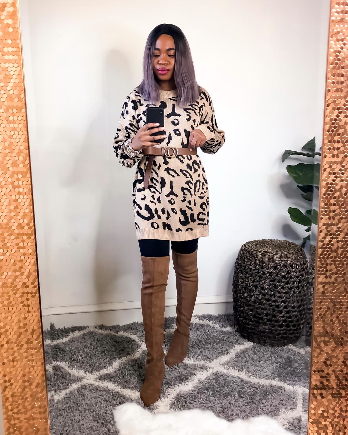 Animal print sweater styled with suede thigh-high boots and belted waist purse