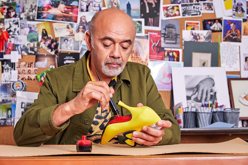 Christian Louboutin painting red soles