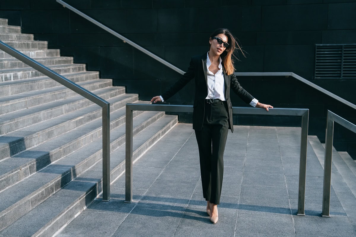 businesswoman in sunglasses strides down stairs ou 2025 01 08 04 13 21 utc