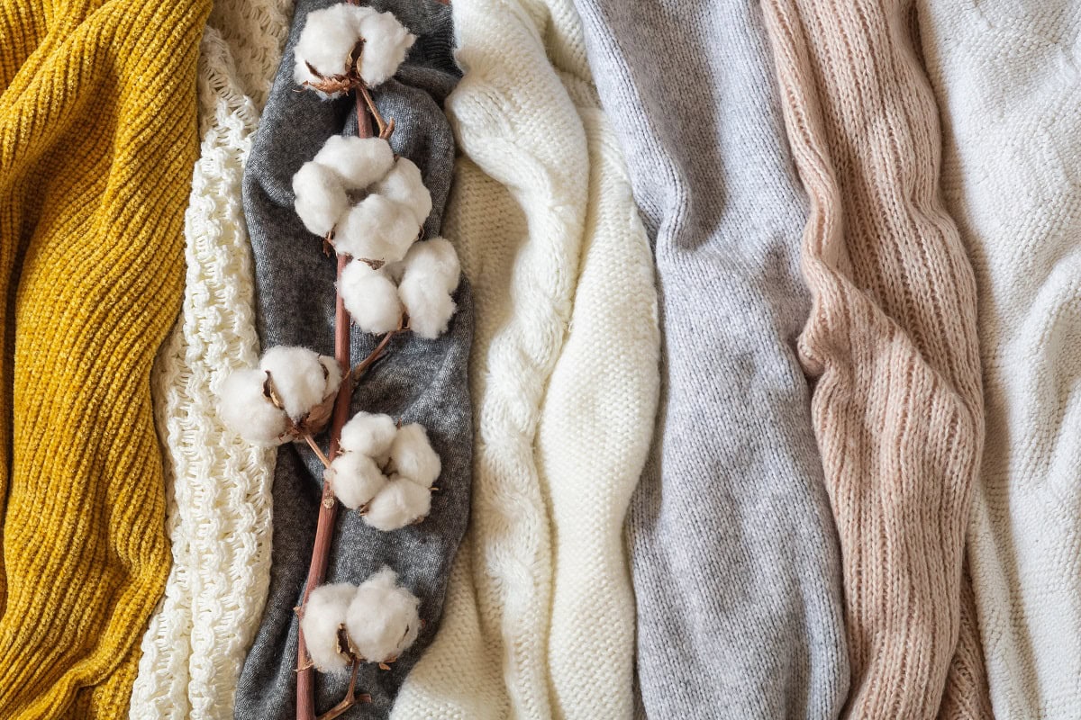 pile of knitted clothes with cotton warm backgrou 2023 11 27 04 58 25 utc
