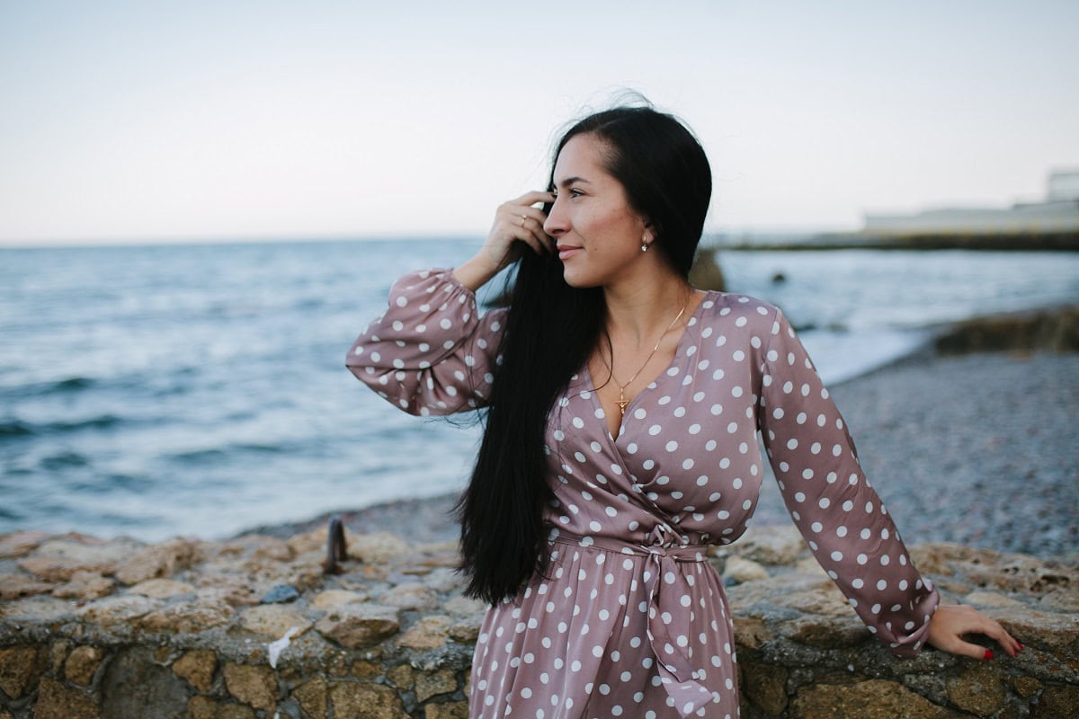 sad girl sitting on the coast on beach and looks i 2023 11 27 05 28 35 utc