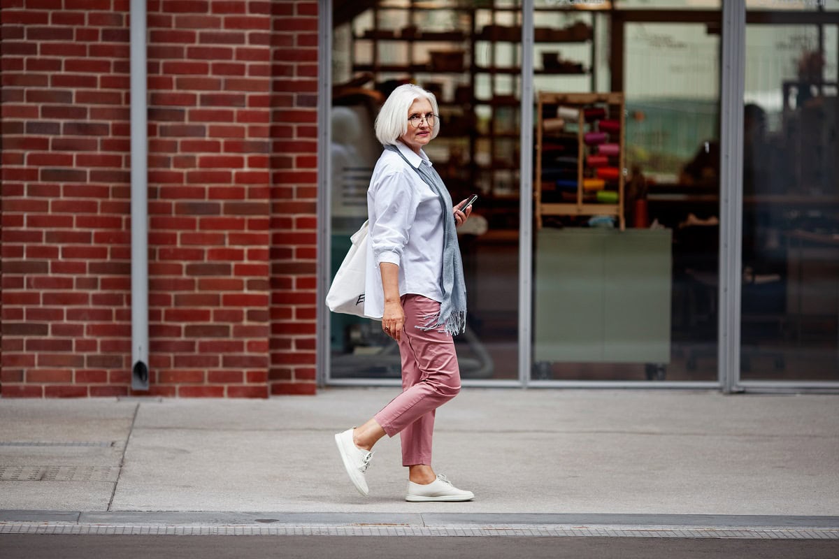 senior woman with short gray hair walks down city 2025 01 16 12 00 34 utc