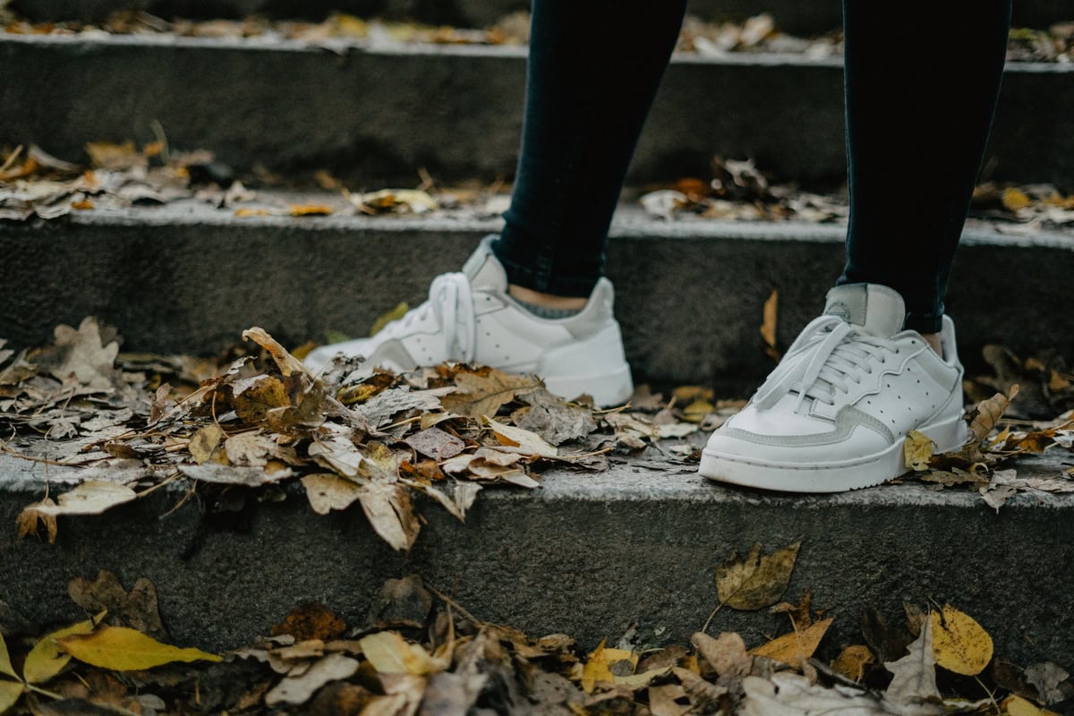 white sneakers shoes in fall season fall leaves 2025 01 09 06 25 15 utc