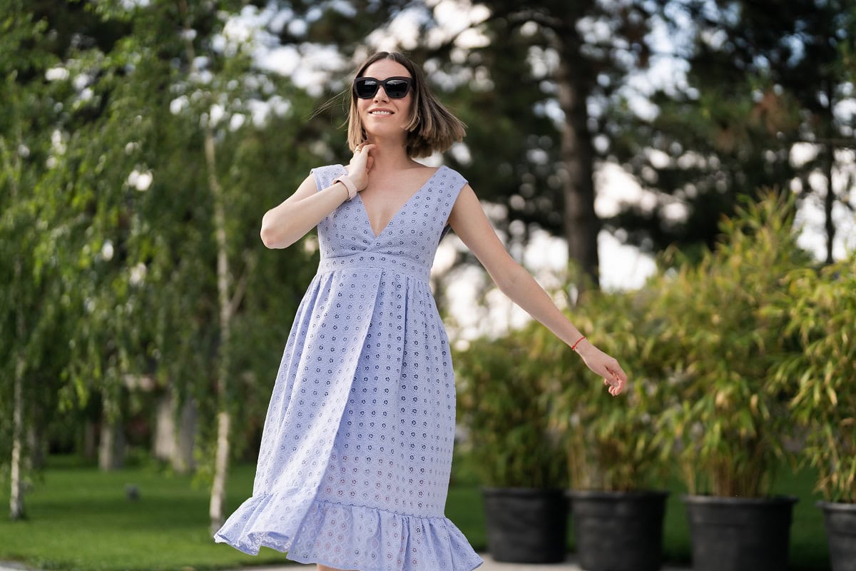 woman in blue dress posing ourdoors on plants back 2024 10 13 21 39 51 utc