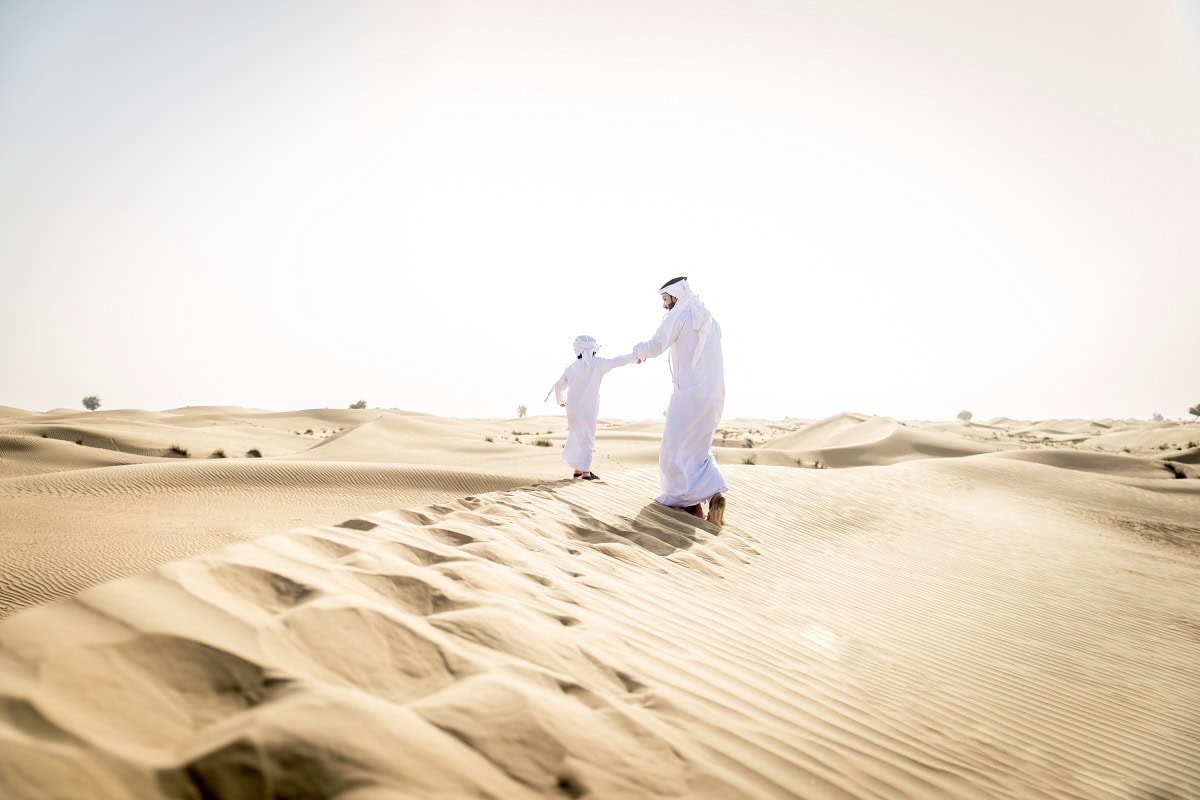 arabian man and son playing in the desert 2023 11 27 05 34 05 utc