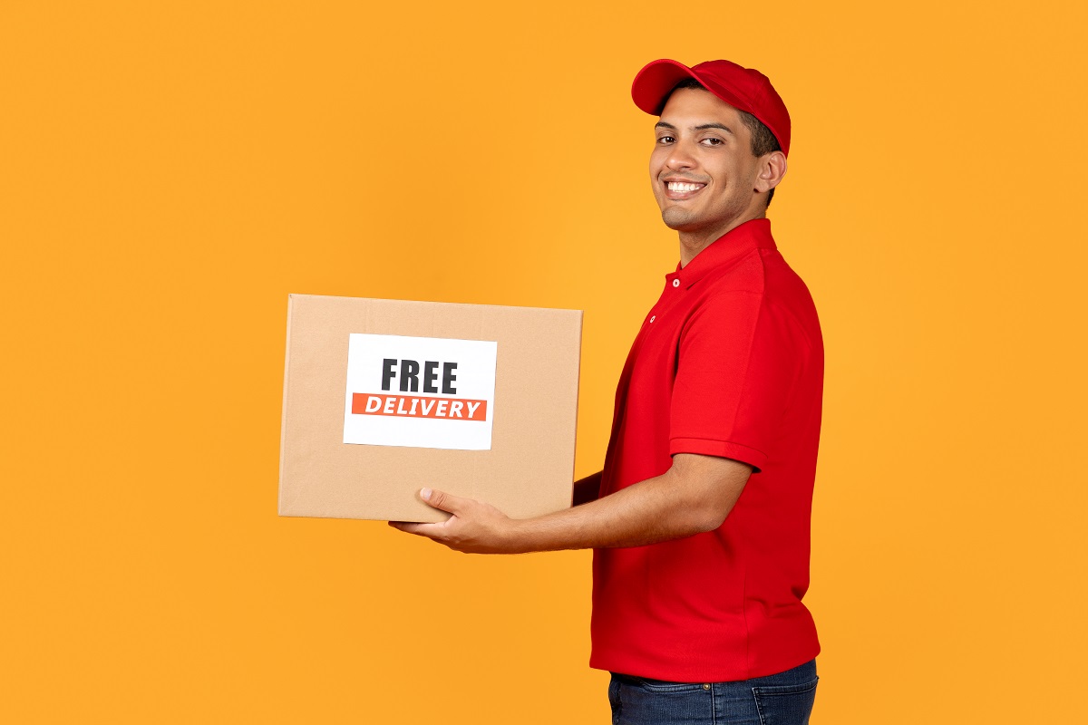 deliveryman holds cardboard box with free delivery 2023 11 27 05 28 50 utc