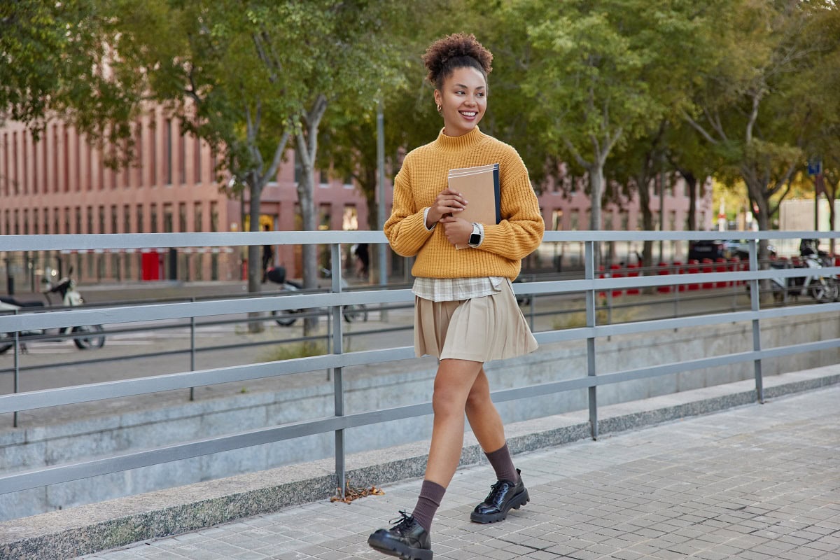 outdoor shot of happy curly haired schoolgirl wear 2025 01 24 00 29 39 utc