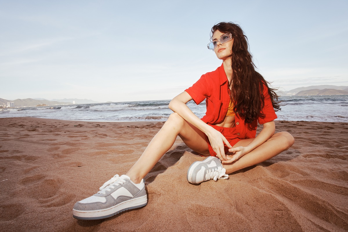 smiling woman in trendy fashion outfit sitting on 2025 03 10 20 29 24 utc