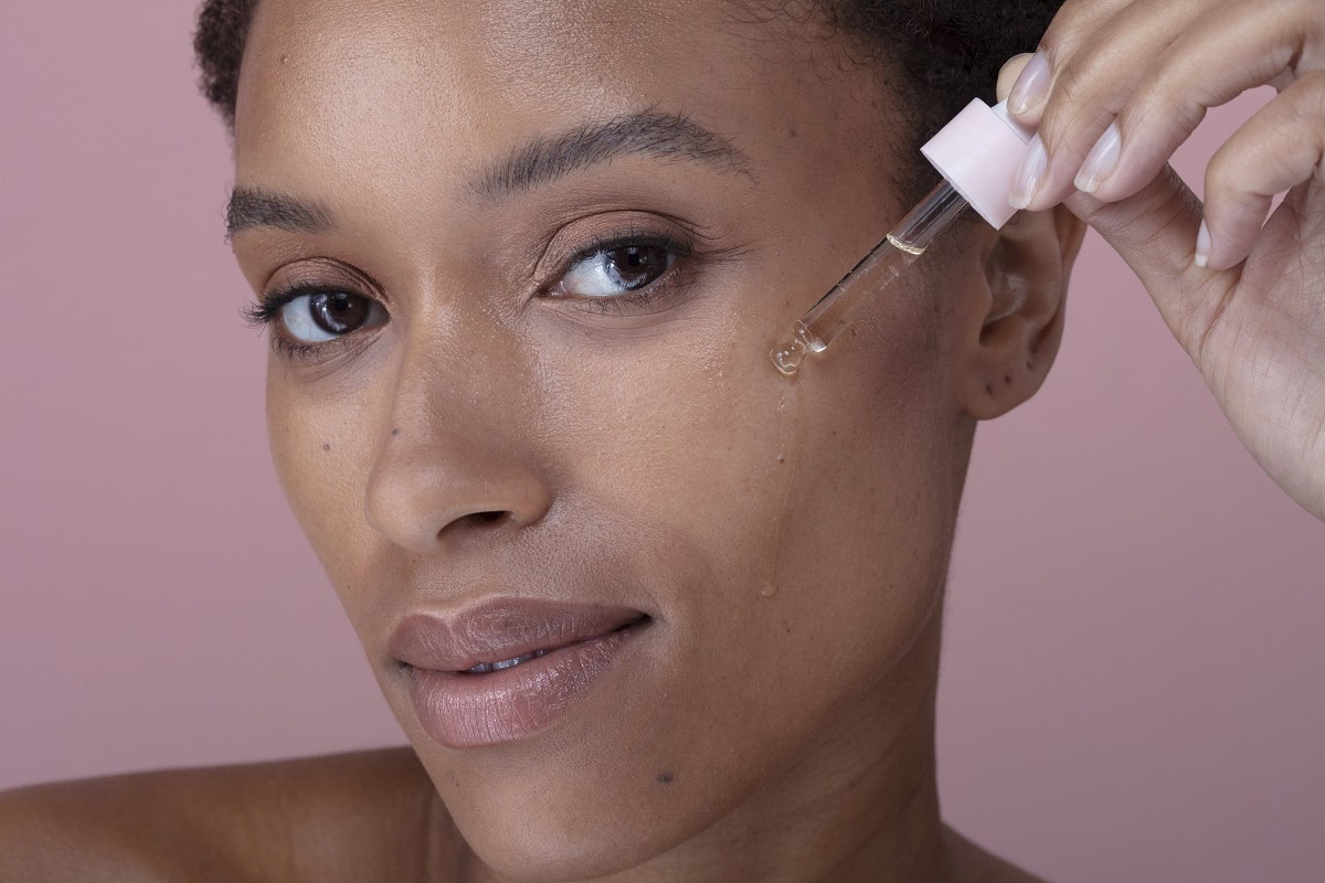 studio portrait of woman dropping cosmetic oil on 2024 07 05 20 24 17 utc