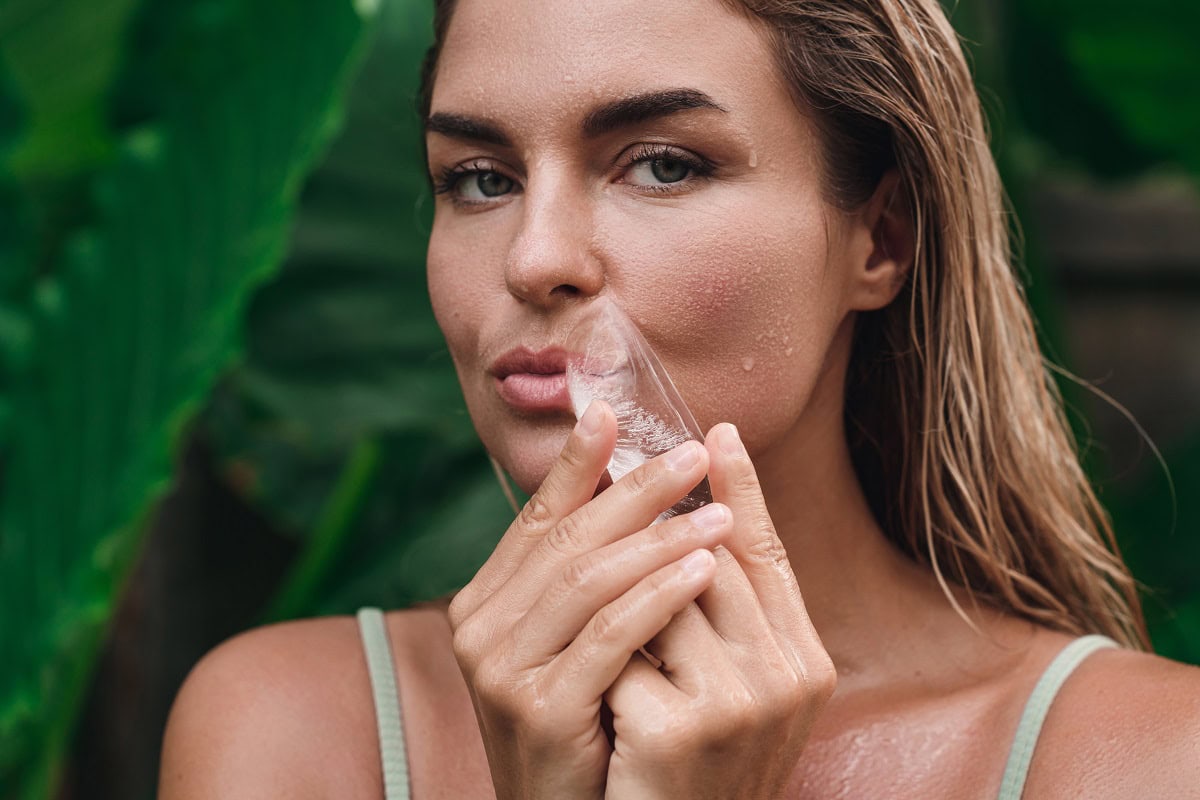 woman cooling her face with an ice crystal surrou 2024 10 18 03 38 39 utc