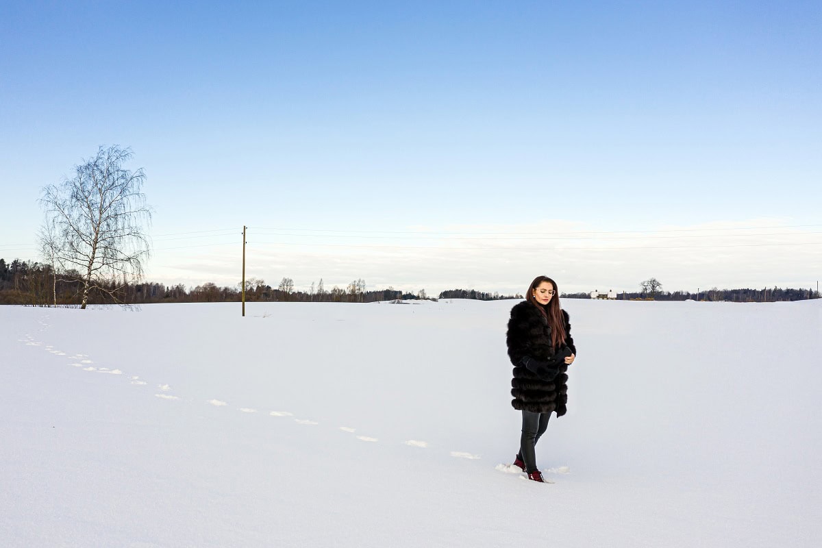 a cheerful woman in a warm fur coat walks across t 2025 03 18 13 49 01 utc
