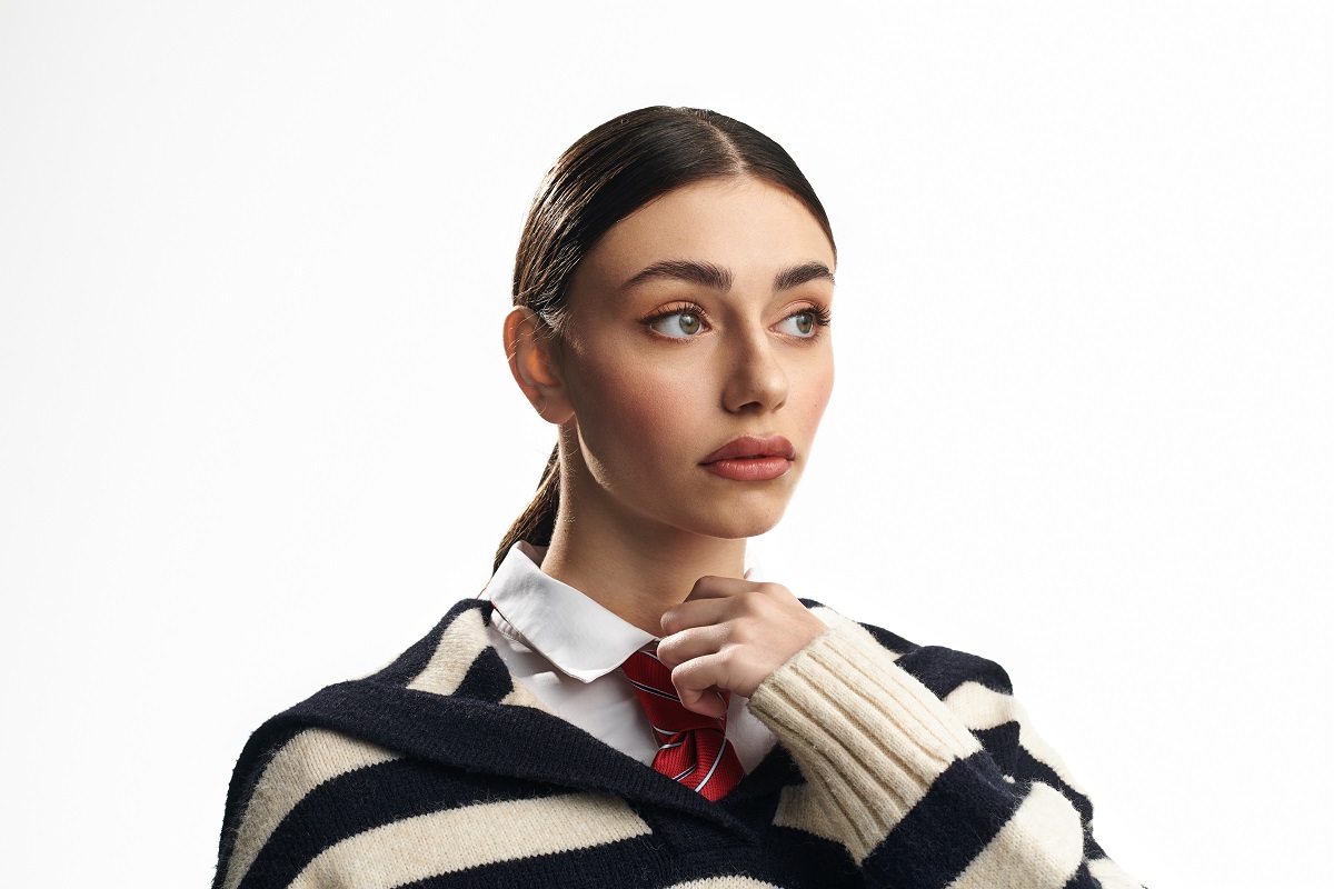 a young woman in a striped sweater conveys deep em 2025 01 31 02 20 32 utc