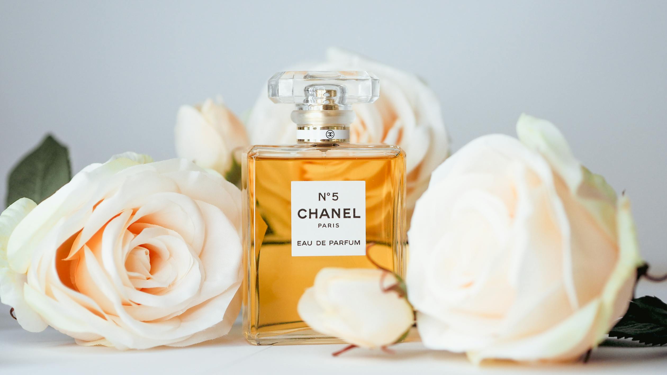free photo of a bottle of chanel no 5 perfume and flowers