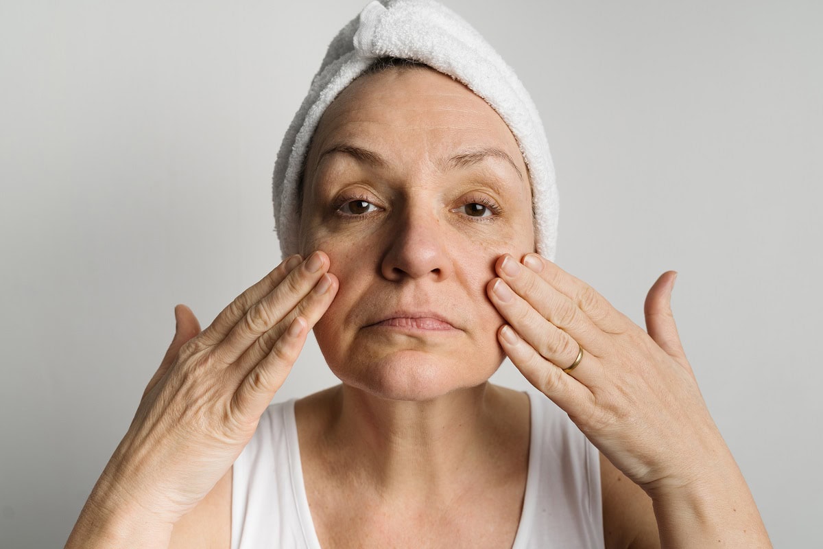 middle aged woman lookin in a mirror and checking 2025 01 08 02 31 01 utc