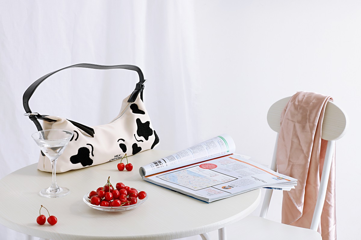 newspaper a purse and red cherries on a table aga 2025 02 09 01 33 18 utc