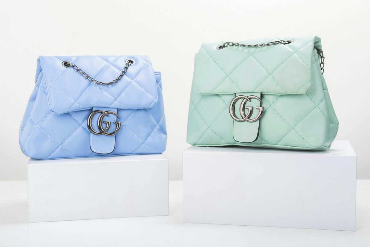 Stylish blue and mint quilted handbags on display, perfect for fashion enthusiasts.