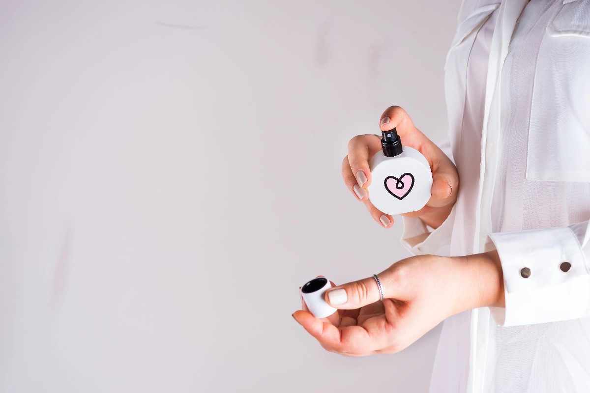 Woman applying perfume